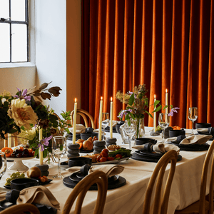 the hom market tablescape with marble dishes candles and linens